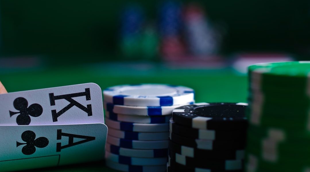 Close-up of playing cards and poker chips on a green felt table